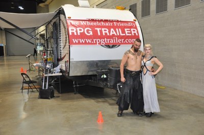 a couple of cosplayers posing in front of RPG Research van